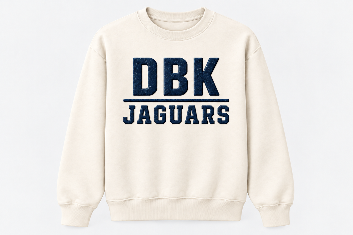 Generated DBK Jaguars navy design concept on cream sweatshirt; supplied garment is LAT Natural Heather
